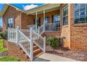 Inviting front porch and steps with white railings, offering a glimpse of the front door at 2232 Triplett Rd, Mt Ulla, NC 28125