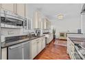 Kitchen features stainless steel appliances, granite countertops, coffee maker, and wooden floors at 224 N Poplar St # 9, Charlotte, NC 28202