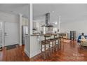 Kitchen with stainless steel appliances, granite countertops, wooden floors and bar seating at 224 N Poplar St # 9, Charlotte, NC 28202