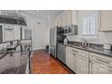 Kitchen features stainless steel refrigerator, sink, granite countertops, and wooden floors at 224 N Poplar St # 9, Charlotte, NC 28202