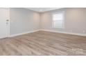 This bedroom offers new luxury vinyl plank flooring and a large window that provides lots of natural light at 2628 Park Rd # F, Charlotte, NC 28209