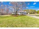 Inviting ranch home with a well-maintained lawn and mature shade tree at 341 Massey Deal Rd, Statesville, NC 28625
