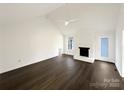 This bright living room includes a vaulted ceiling and a cozy fireplace at 3632 Farm Lake Sw Dr, Concord, NC 28027