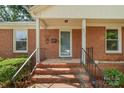 Close up of the front entrance, with brick steps, black railings, and space to welcome your guests at 3714 Conway Ave, Charlotte, NC 28209