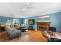 Spacious living room featuring hardwood floors, large windows and fireplace with wood trim at 3714 Conway Ave, Charlotte, NC 28209
