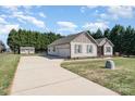 Attractive ranch-style home with neutral siding, attached garage and long driveway at 430 Cress School Rd, Salisbury, NC 28147