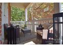 Relaxing covered porch featuring comfortable seating, a stylish rug, and a serene outdoor ambiance at 4860 S Hill View Dr, Charlotte, NC 28210