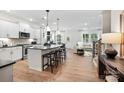 Open-concept kitchen with an island and seating flowing into the living area at 5220 Hatcher Creek Rd # 56, Charlotte, NC 28215