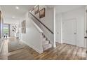 Bright foyer features hardwood floors, staircase, and neutral decor at 558 Mountain View Dr, Monroe, NC 28110