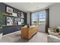 Home office with floating shelves, modern desk, and bright natural light at 558 Mountain View Dr, Monroe, NC 28110