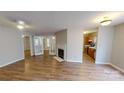 Bright living room with laminate floors, a fireplace, and glass doors leading to another room at 5921 Amity Springs Dr, Charlotte, NC 28212