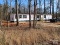 Exterior view of a single-story home with fresh landscaping surrounded by trees at 635 Acre Ct, York, SC 29745