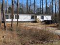 Close-up of the home's exterior, showing the front entrance and a large black dumpster at 635 Acre Ct, York, SC 29745