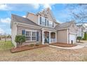 Charming two-story home with a brick and siding exterior, blue shutters, and well-manicured landscaping at 696 Yvonne Sw Dr, Concord, NC 28027