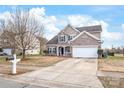 Charming two-story home with a brick and siding exterior, blue shutters, and well-manicured landscaping at 696 Yvonne Sw Dr, Concord, NC 28027