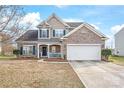 Charming two-story home with a brick and siding exterior, blue shutters, and well-manicured landscaping at 696 Yvonne Sw Dr, Concord, NC 28027