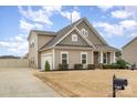 Inviting home featuring an attached garage, manicured lawn, and a classic mailbox, offering a suburban charm at 7413 Adirondack Dr, Denver, NC 28037