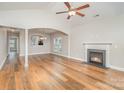 Bright living room featuring hardwood floors, a fireplace, and an open layout with ample natural light at 7413 Adirondack Dr, Denver, NC 28037