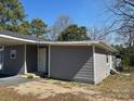 Gray house with a new door and windows, complemented by neutral landscaping at 811 Sanford St, Marshville, NC 28103