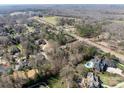 An aerial shot showcasing a residential area with sprawling homes and lush landscaping in a serene setting at 8328 Victoria Lake Dr, Waxhaw, NC 28173