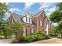 Charming two-story home showcasing a well-manicured lawn and classic brick facade at 9423 Belmont Ln, Marvin, NC 28173