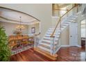 Elegant foyer with hardwood floors, a staircase, and dining room access, creating a welcoming ambiance at 9423 Belmont Ln, Marvin, NC 28173