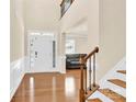 Welcoming entryway with hardwood floors, staircase, and view into the living room at 982 Old Trace Nw Rd, Concord, NC 28027