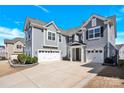 Two-story home featuring a three-car garage and lush landscaping at 982 Old Trace Nw Rd, Concord, NC 28027