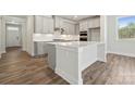 Modern kitchen with white cabinets, ample counter space, a center island, and stainless steel appliances at 9932 Manor Vista Trl, Kannapolis, NC 28027