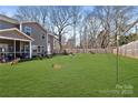 Expansive backyard with lush green grass, bordered by mature trees, perfect for outdoor entertaining and relaxation at 1036 Bramcote Ln, Charlotte, NC 28215