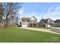 Inviting two-story home with a pristine lawn, complemented by professional landscaping and a welcoming driveway at 1036 Bramcote Ln, Charlotte, NC 28215