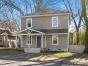 Charming two-story home with gray siding, a covered front porch, and a well-maintained lawn at 105 S York St, Lancaster, SC 29720