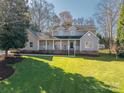 Charming two-story home featuring a welcoming front porch and a well-manicured lawn on a sunny day at 107 Doris Ct, Lincolnton, NC 28092