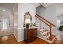 Elegant foyer with hardwood floors, a staircase, and decorative mirror adding warmth and character at 107 Doris Ct, Lincolnton, NC 28092