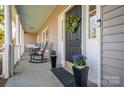 Inviting covered porch with rocking chairs, planters, and a welcoming wreath on the front door at 107 Doris Ct, Lincolnton, NC 28092