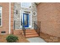 Close up of the front door with brick steps and iron railings at 109 Stirling Heights Ln, Fort Mill, SC 29715