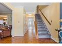 Inviting foyer with hardwood floors and staircase leading to the upper level at 11834 Mallard Ridge Dr, Charlotte, NC 28269