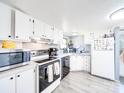 Efficient kitchen featuring white cabinets, updated appliances, and ample counter space at 137 Beaverbrook Rd, Statesville, NC 28677