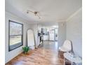 Bright living room featuring wood floors, white brick accent wall, and kitchen view at 137 Beaverbrook Rd, Statesville, NC 28677
