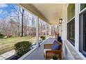 Expansive covered porch with ample seating and views of the wooded front yard at 176 Chestnut Ln, Gastonia, NC 28052