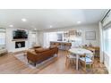 Open floor plan with hardwood floors, a fireplace and a modern kitchen in view at 176 Chestnut Ln, Gastonia, NC 28052