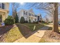 Well-maintained home showcasing a neat lawn, established landscaping, and sidewalk access at 17818 Overland Forest Dr, Cornelius, NC 28031