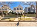 Inviting two-story home with a covered front porch, set amongst manicured lawns and mature trees at 17818 Overland Forest Dr, Cornelius, NC 28031