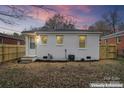 Cozy backyard featuring a newly painted white brick home and enhanced lawn at 1826 Taylor Ave, Charlotte, NC 28216