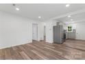 Open living room showcasing wood floors, modern lighting, and neutral paint at 1826 Taylor Ave, Charlotte, NC 28216
