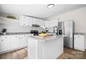 Bright kitchen featuring white cabinetry, granite countertops, stainless steel appliances, and a kitchen island at 1841 Ellick Dr, Newton, NC 28658