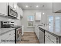 Modern kitchen featuring stainless steel appliances, granite countertops, and ample cabinet space at 2021 Mcdonald Dr, Charlotte, NC 28216