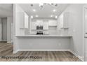 Bright kitchen featuring white cabinets, granite countertops, stainless steel appliances, and breakfast bar seating at 2021 Mcdonald Dr, Charlotte, NC 28216