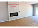 Bright living room with a modern linear fireplace, creating a cozy and inviting space at 2021 Mcdonald Dr, Charlotte, NC 28216