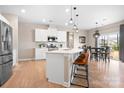 Bright kitchen with white cabinets, stainless steel appliances, and an island with bar seating at 2024 Linn Cv, Waxhaw, NC 28173
